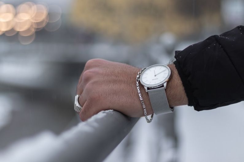 Outfit Jewelry - person wearing silver round analog watch with black leather strap