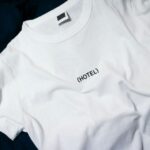 Outfit Prints - white hotel-printed crew-neck shirt on black surface