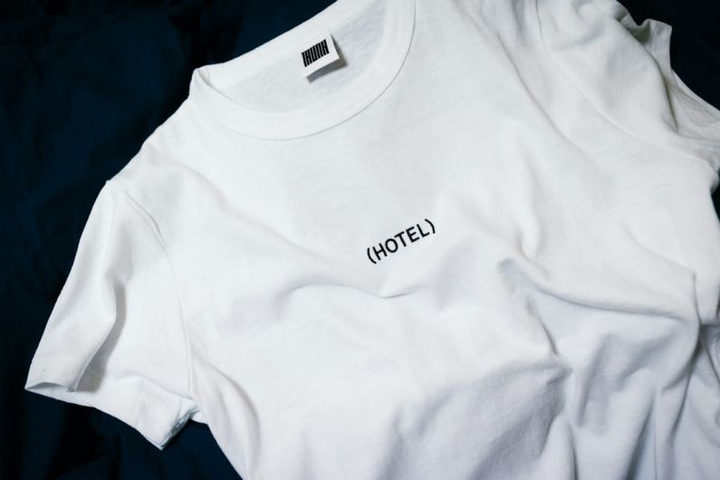 Outfit Prints - white hotel-printed crew-neck shirt on black surface