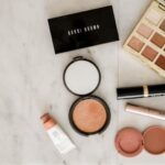 Beauty - photo of assorted makeup products on gray surface