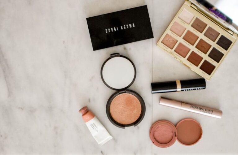 Beauty - photo of assorted makeup products on gray surface
