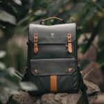 Bags - selective focus photography of black and brown leather backpack on rock