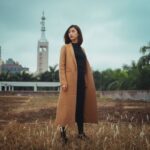 Coat - woman wearing brown coat standing on brown grass