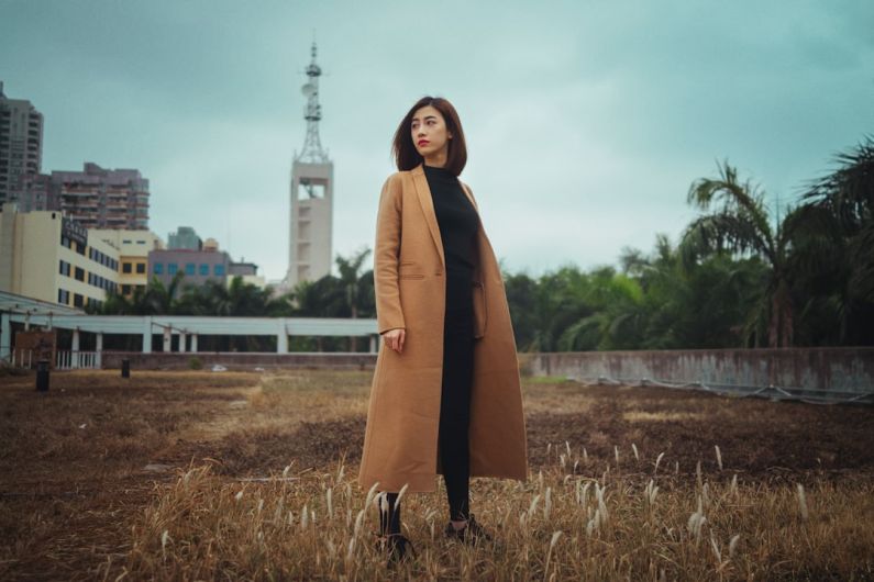 Coat - woman wearing brown coat standing on brown grass