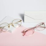 Eyewear - gold framed eyeglasses on white paper