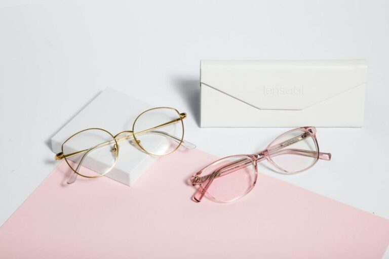 Eyewear - gold framed eyeglasses on white paper
