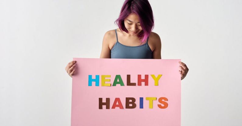 Healthy Habits - Woman Looking at the Pink Poster She's Holding