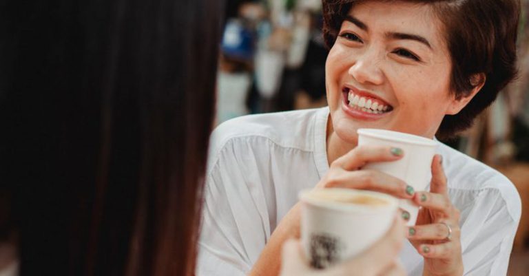 Best Coffee Shops - Cheerful Asian women drinking coffee in outdoor cafeteria