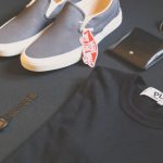 Endorsed Brands - Pair of Gray Vans Low-top Sneakers Beside Black Shirt, Sunglasses, and Watch