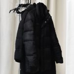 Casual Wardrobe - White curtains and stylish jackets on metal hanger in spacious room at home