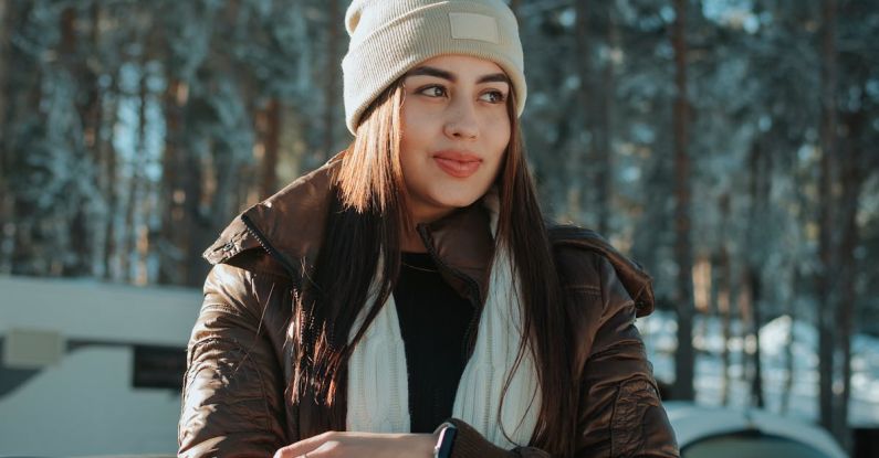 Clothes Alteration - A woman in a winter jacket leaning against the hood of a car