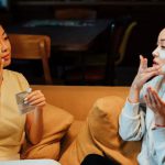 Home Spa DIY - Woman in White Sweater and Black Pants Sitting on Brown Couch