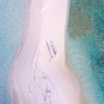 Luxury Budget Travel - aerial photography of couple standing between body of water