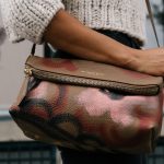 Handbags Trend - woman holding brown and pink floral leather crossbody bag