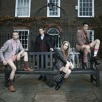 Unique Fashion - photography of group of people sitting on bench