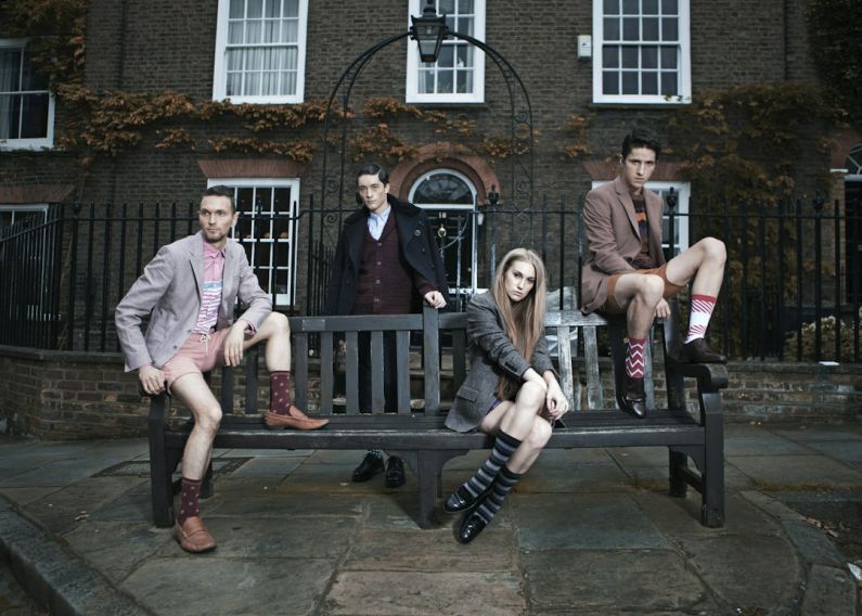 Unique Fashion - photography of group of people sitting on bench