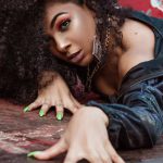 Strong Nails - Beautiful Woman with Long Curly Hair Laying on Garbage Container