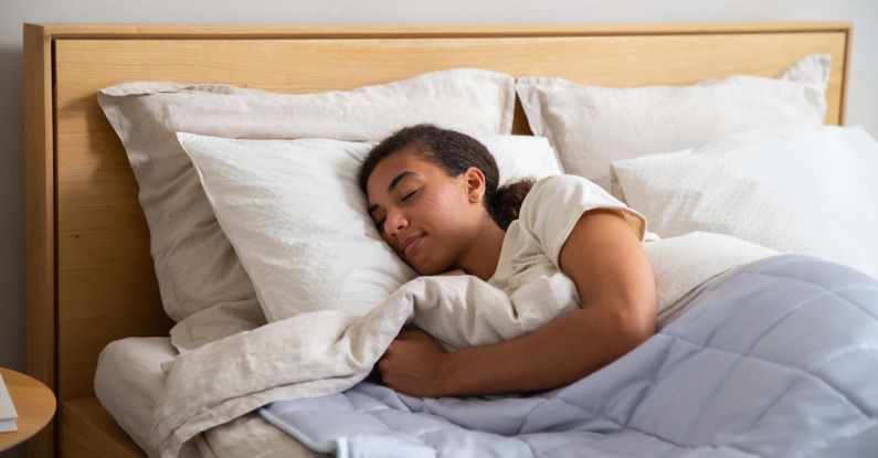 Sleep Quality - A woman sleeping in a bed with a blanket
