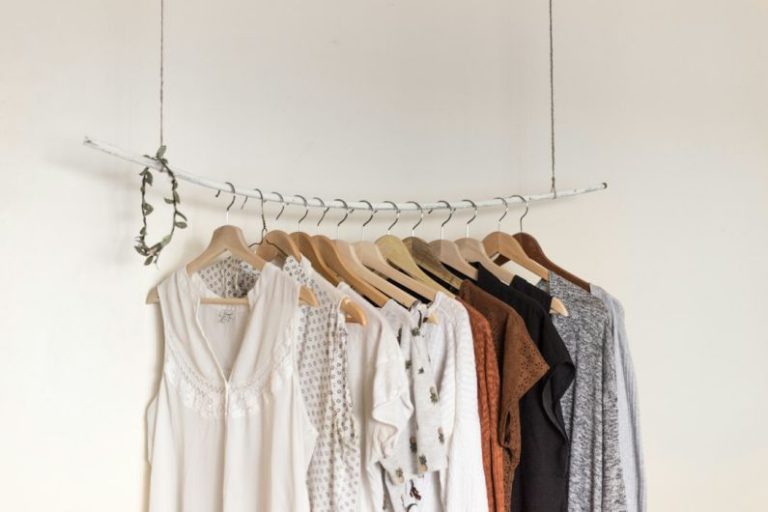 Capsule Wardrobe - assorted clothes in wooden hangers