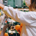 Health Food Stores - Woman in White Long Sleeve Jacket Shopping For Fruits