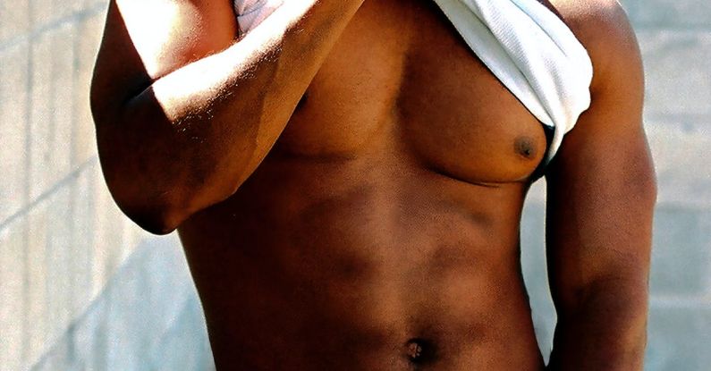 Fitness Conferences - A shirtless man with jeans and a belt holding a cigarette